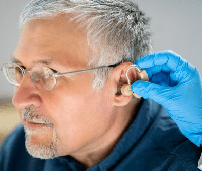 Older man getting a hearing aid